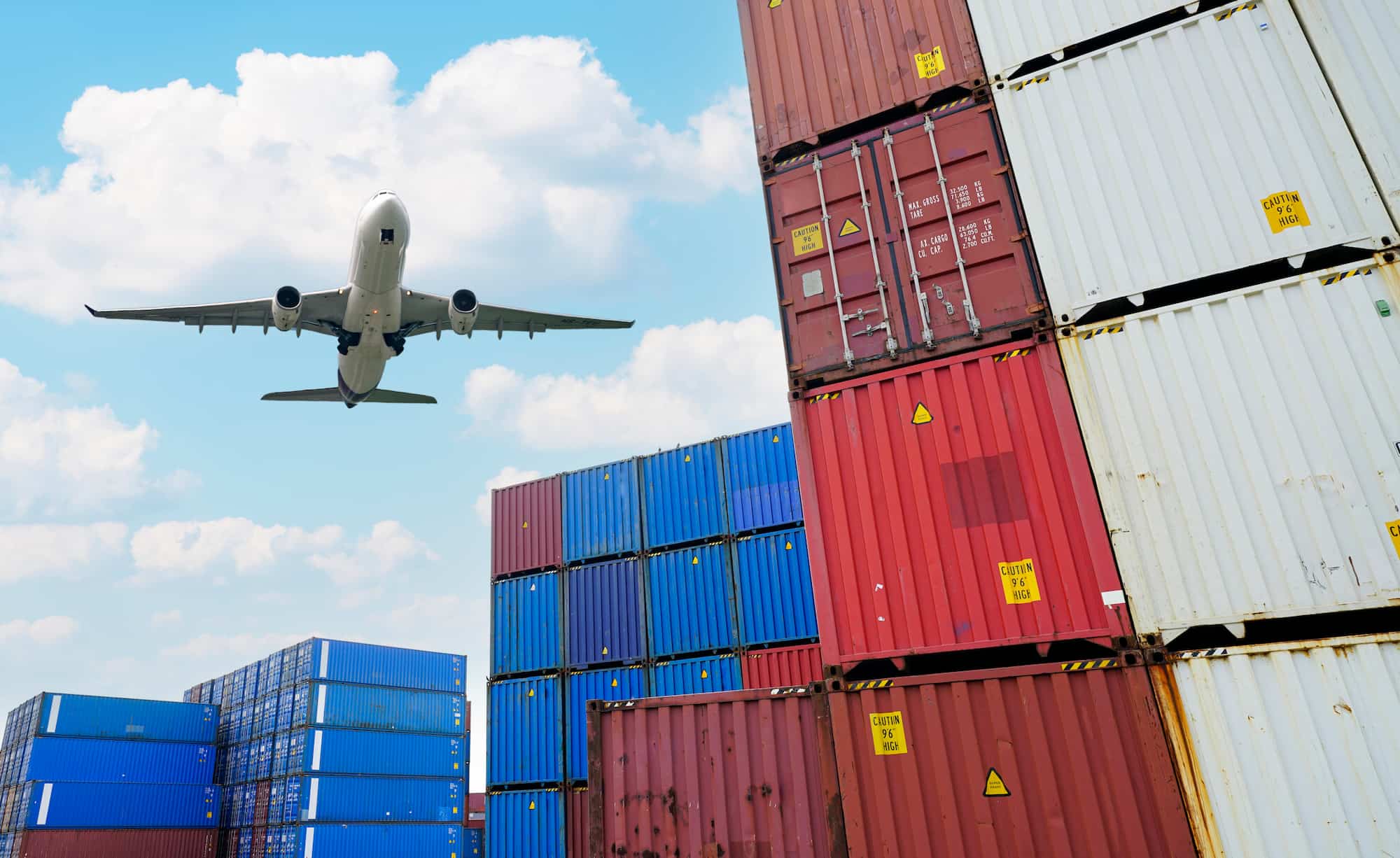 Freight aircraft loading cargo containers at an airport